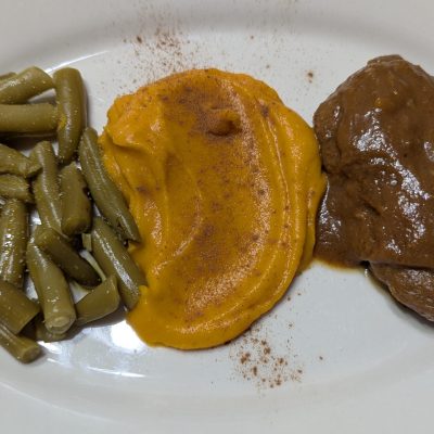 Chicken glazed with peach sauce, a creamy butternut squash puree with honey, butter, and cinnamon, and a side of canned green beans.